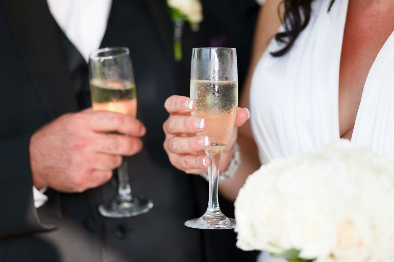 Mastering the First Impression: Your intriguing post title goes here Bride and groom toasting with champagne at their wedding celebration.